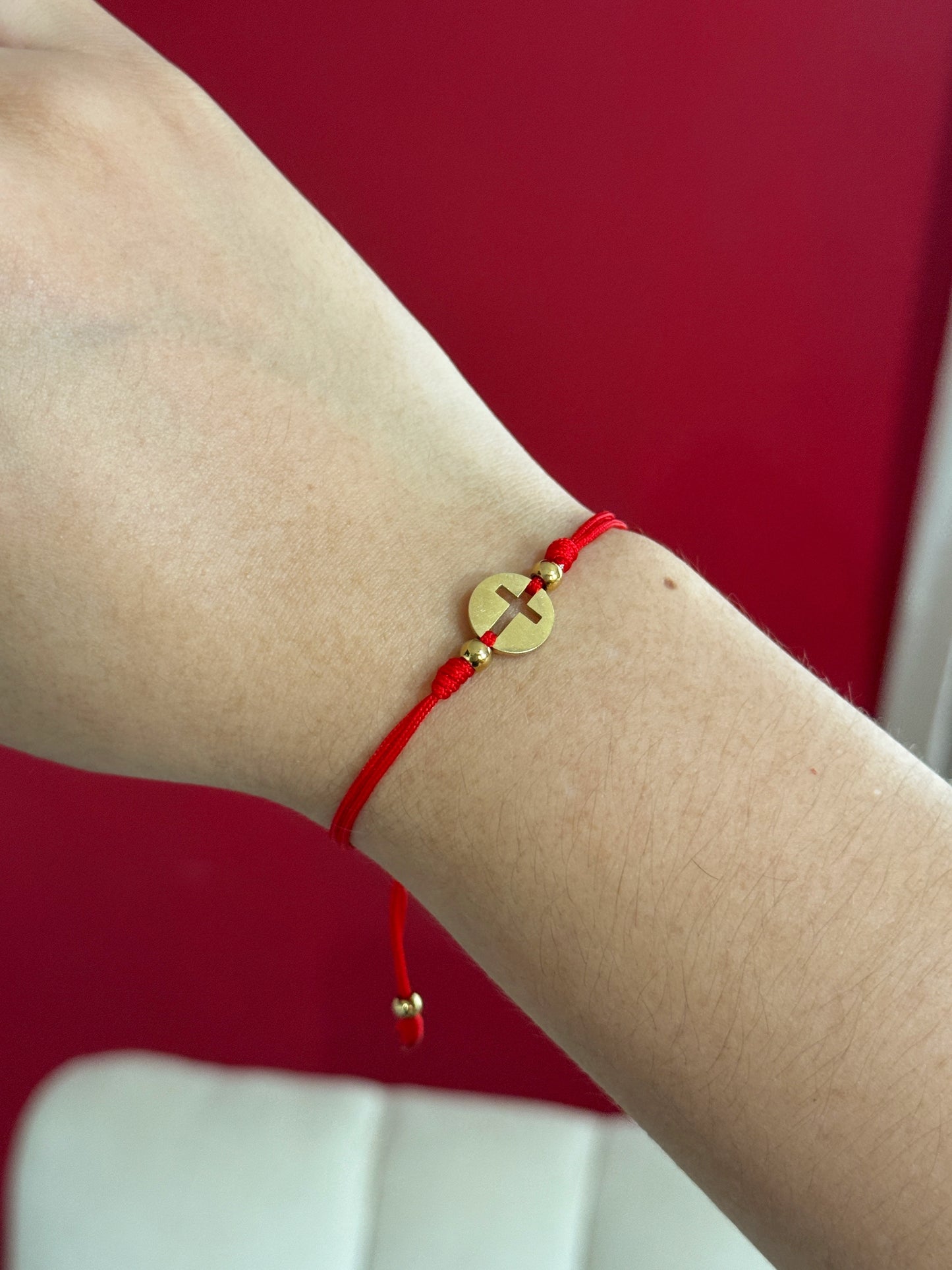 Hilo rojo con medalla cruz